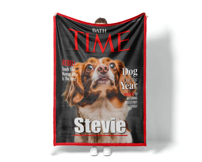 May include: A fleece dog blanket features a custom-designed Time magazine cover. The cover showcases a brown and white dog, identified as 'Stevie,' as the 'Dog of the Year.'  Red and black text highlights the magazine title and playful captions like 'Rebel' and 'Secrets to becoming irresistibly cuddly.' The blanket is a soft, plush material, perfect for pet owners who want a unique and personalized gift.