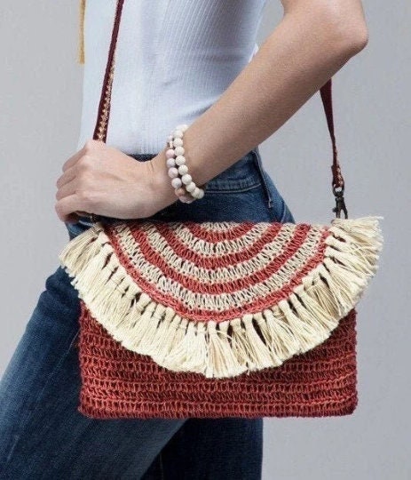 Bohemian inspired handmade jute cross-body bag featuring fringe detail with a fully lined pocket inside and a magnetic closure