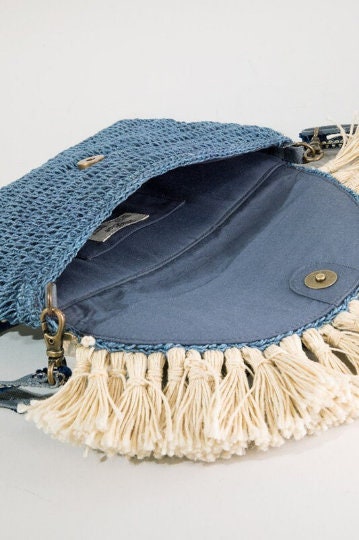 Bohemian inspired handmade jute cross-body bag featuring fringe detail with a fully lined pocket inside and a magnetic closure