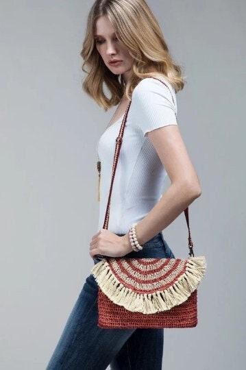 Bohemian inspired handmade jute cross-body bag featuring fringe detail with a fully lined pocket inside and a magnetic closure